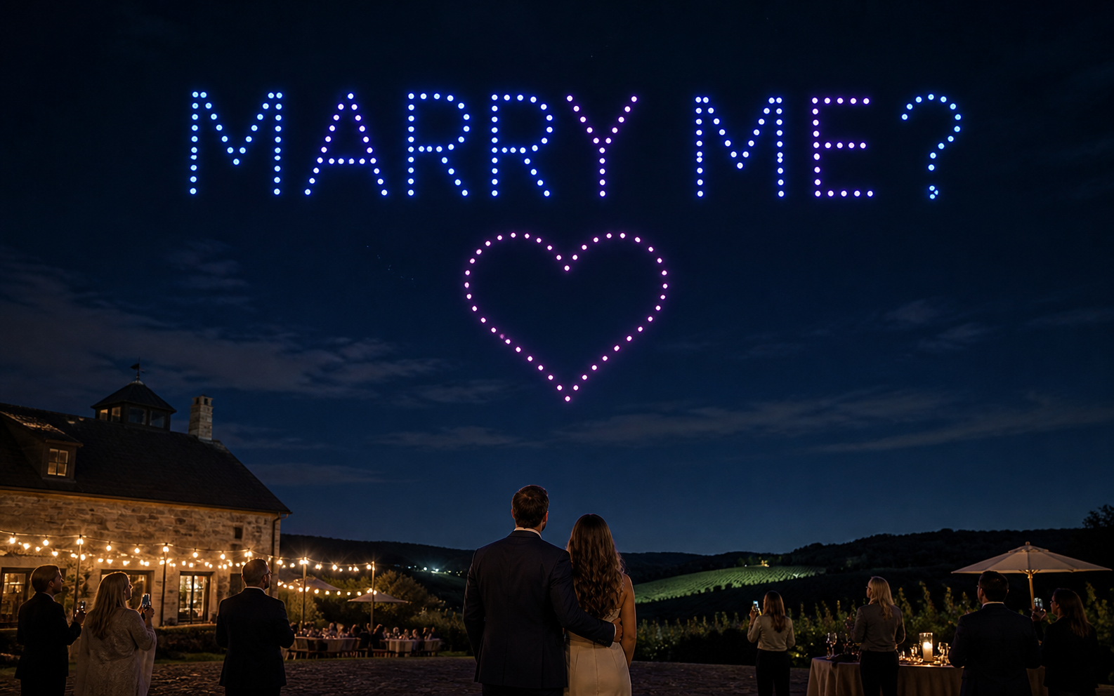Marry me and a heart formed by a small-fleet drone light show above an intimate celebration